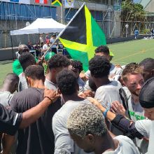 Jamaica's Lacrosse Team Huddles after Qualifying